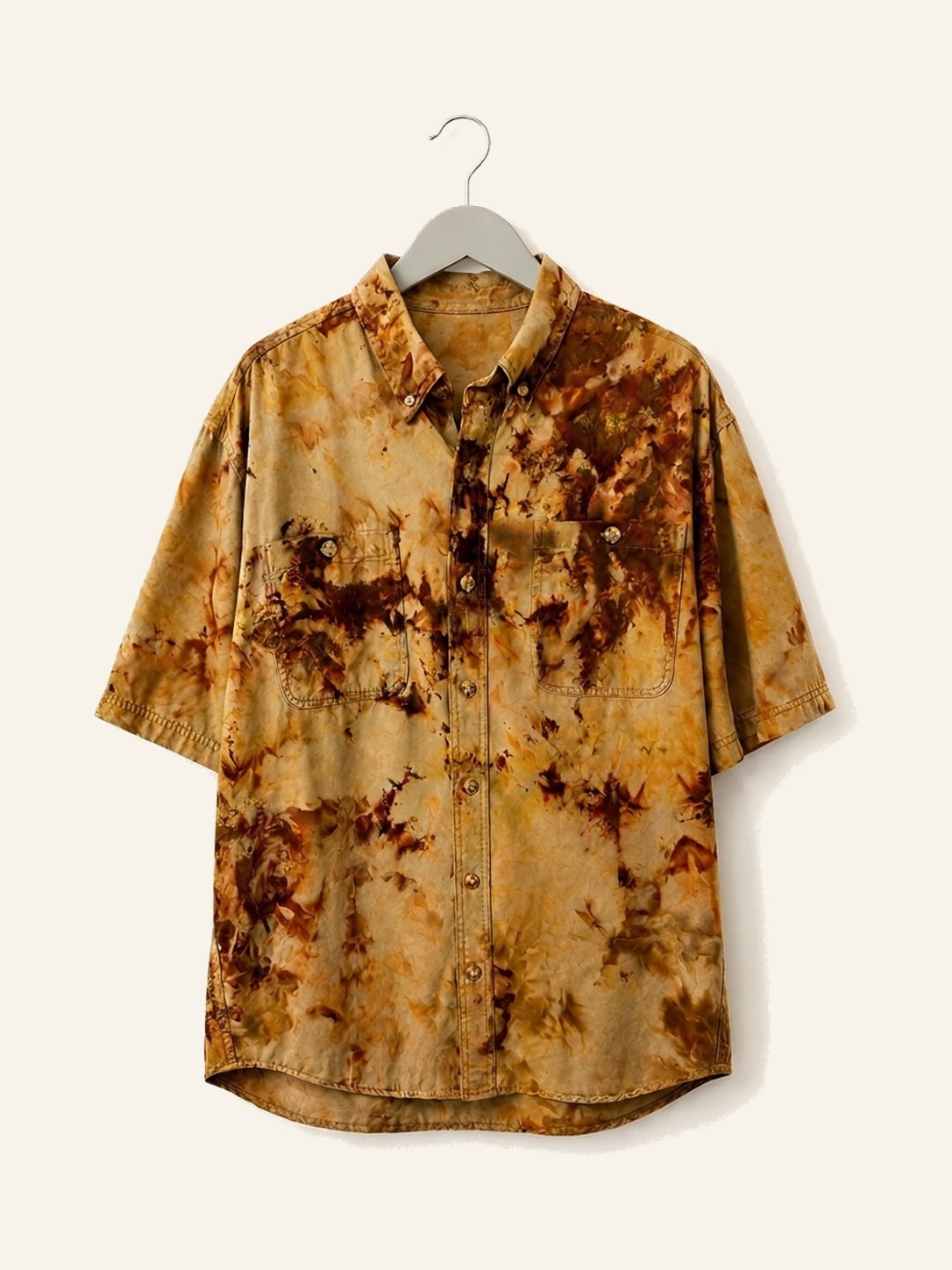 Hand ice-dyed cotton shirt in khaki, ochre and umber on a pale grey hanger