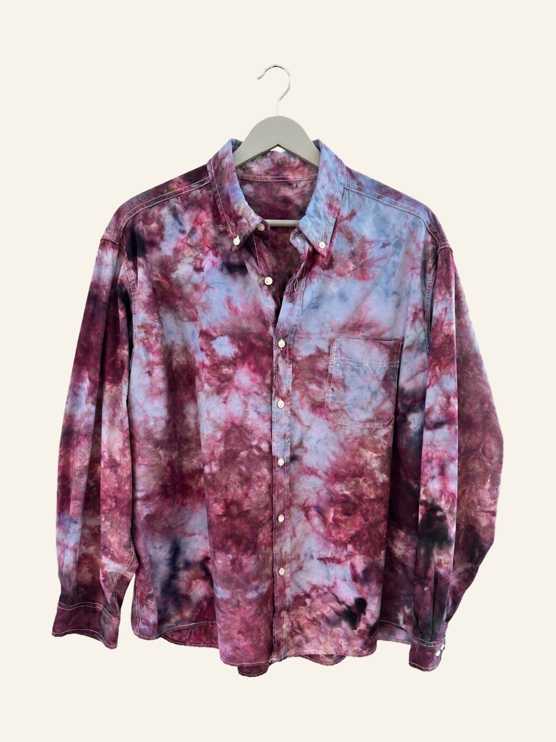 Hand ice-dyed cotton long-sleeve shirt in violet, plum, and dusty blue on a pale grey hanger