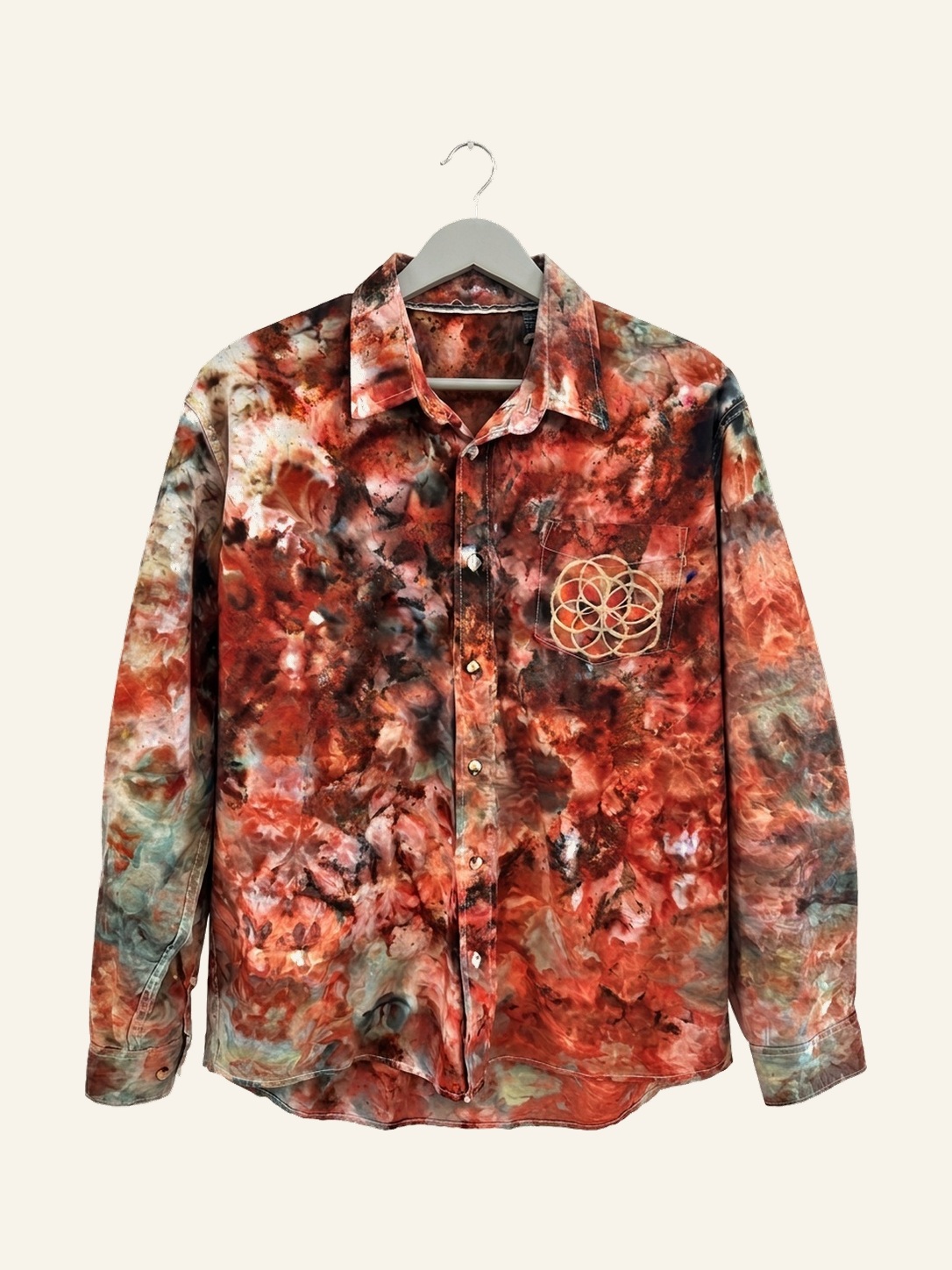Hand ice-dyed cotton shirt in rust and umber on a pale grey hanger