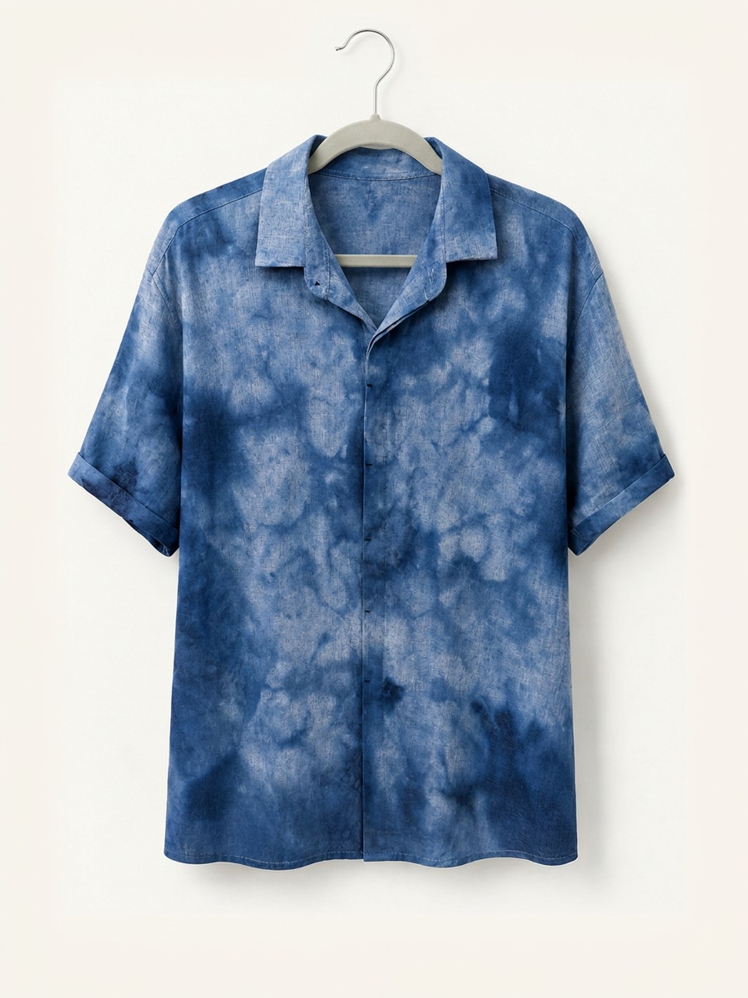 Hand ice-dyed bamboo and linen blue camp collar shirt on a wooden hanger