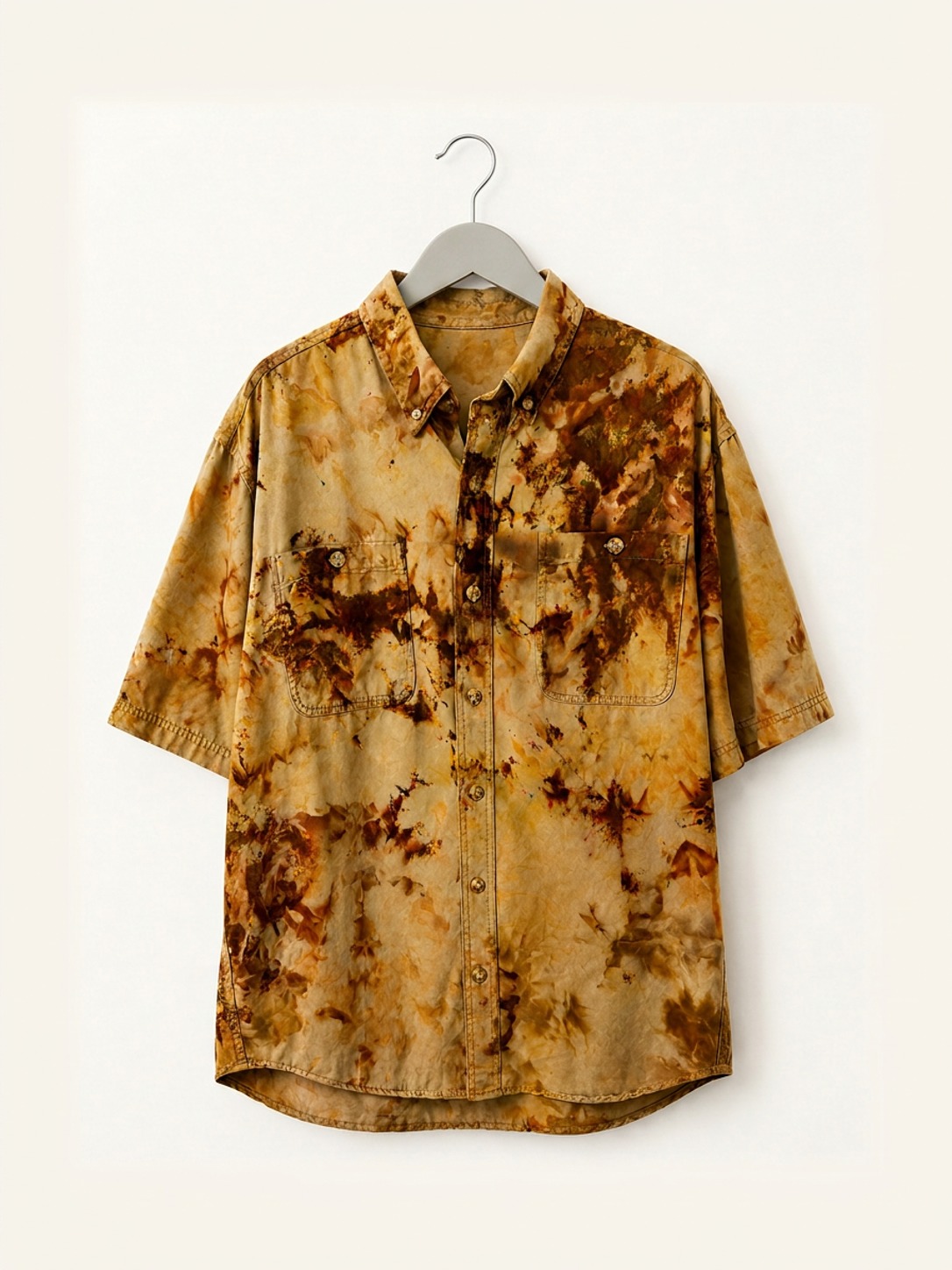 Hand ice-dyed cotton shirt in khaki, ochre and umber on a wooden hanger