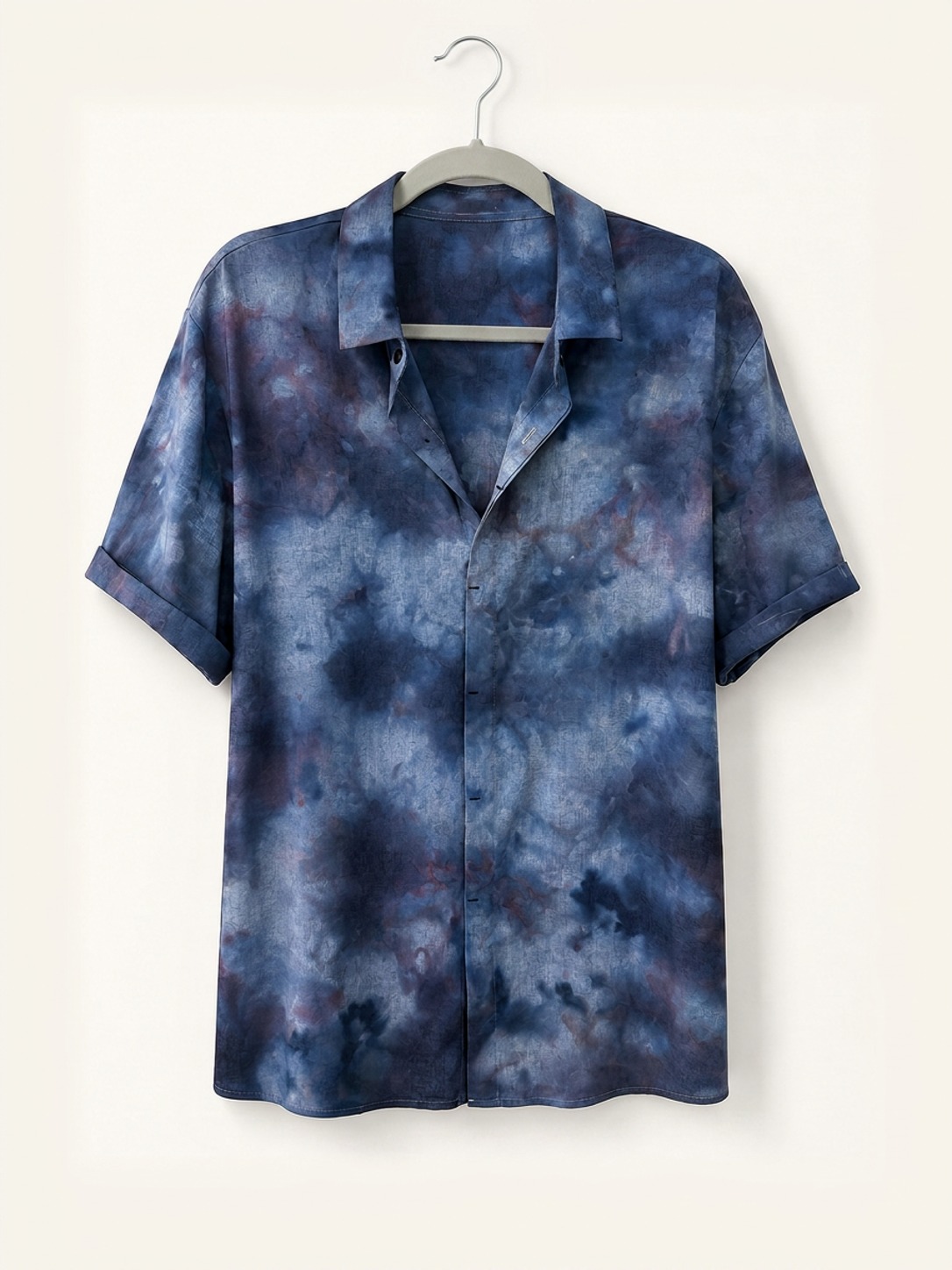 Hand ice-dyed bamboo and linen deep blue and plum camp collar shirt on a wooden hanger