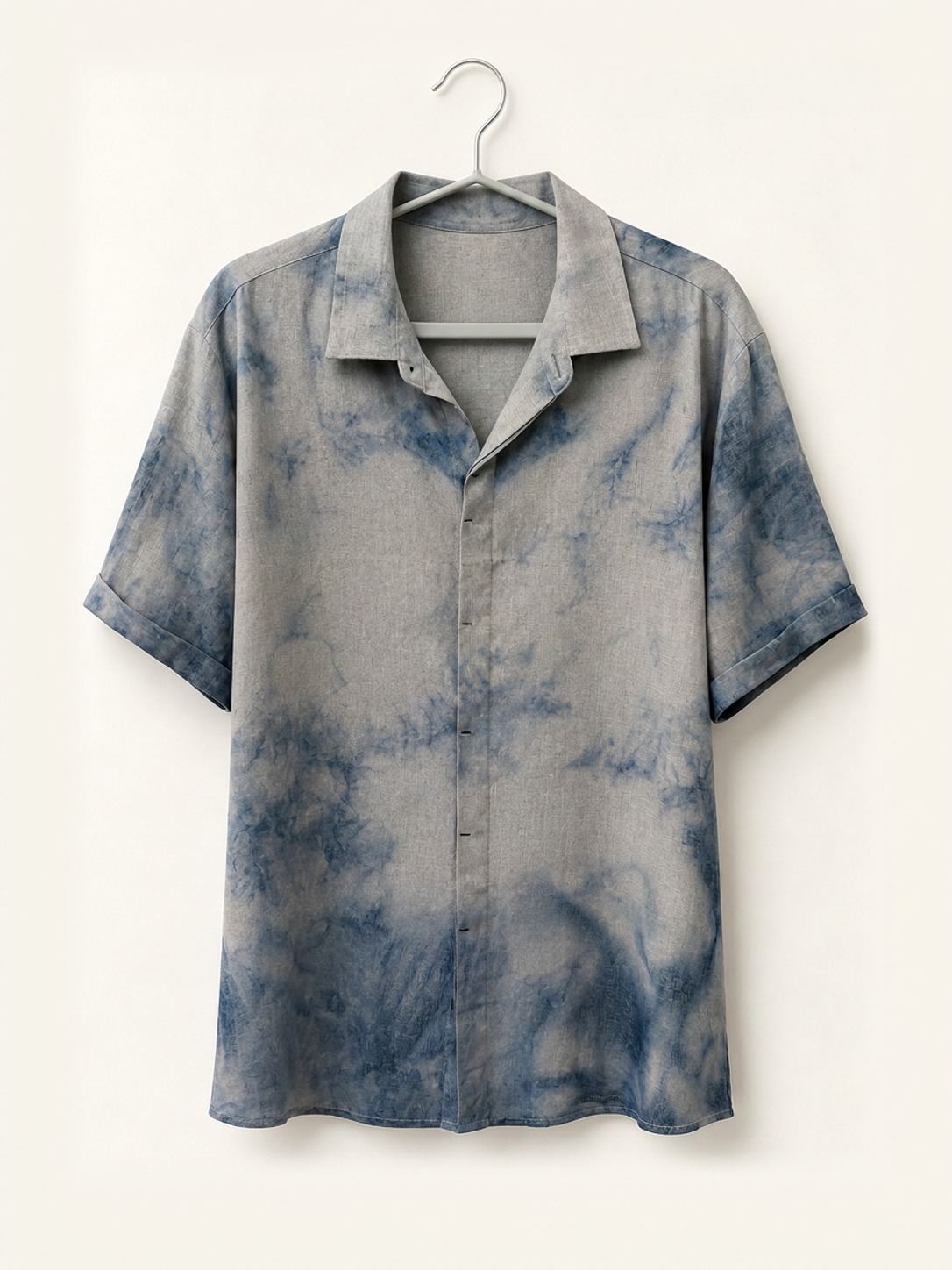 Hand ice-dyed bamboo and linen grey and soft blue camp collar shirt on a wooden hanger