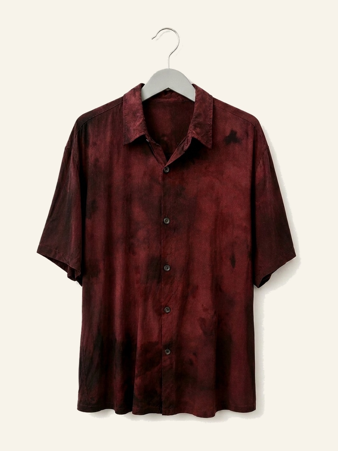 Hand ice-dyed bamboo shirt in deep red and black on a wooden hanger