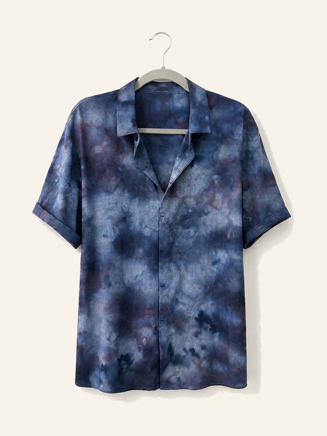 Hand ice-dyed bamboo and linen deep blue and plum shirt on a wooden hanger