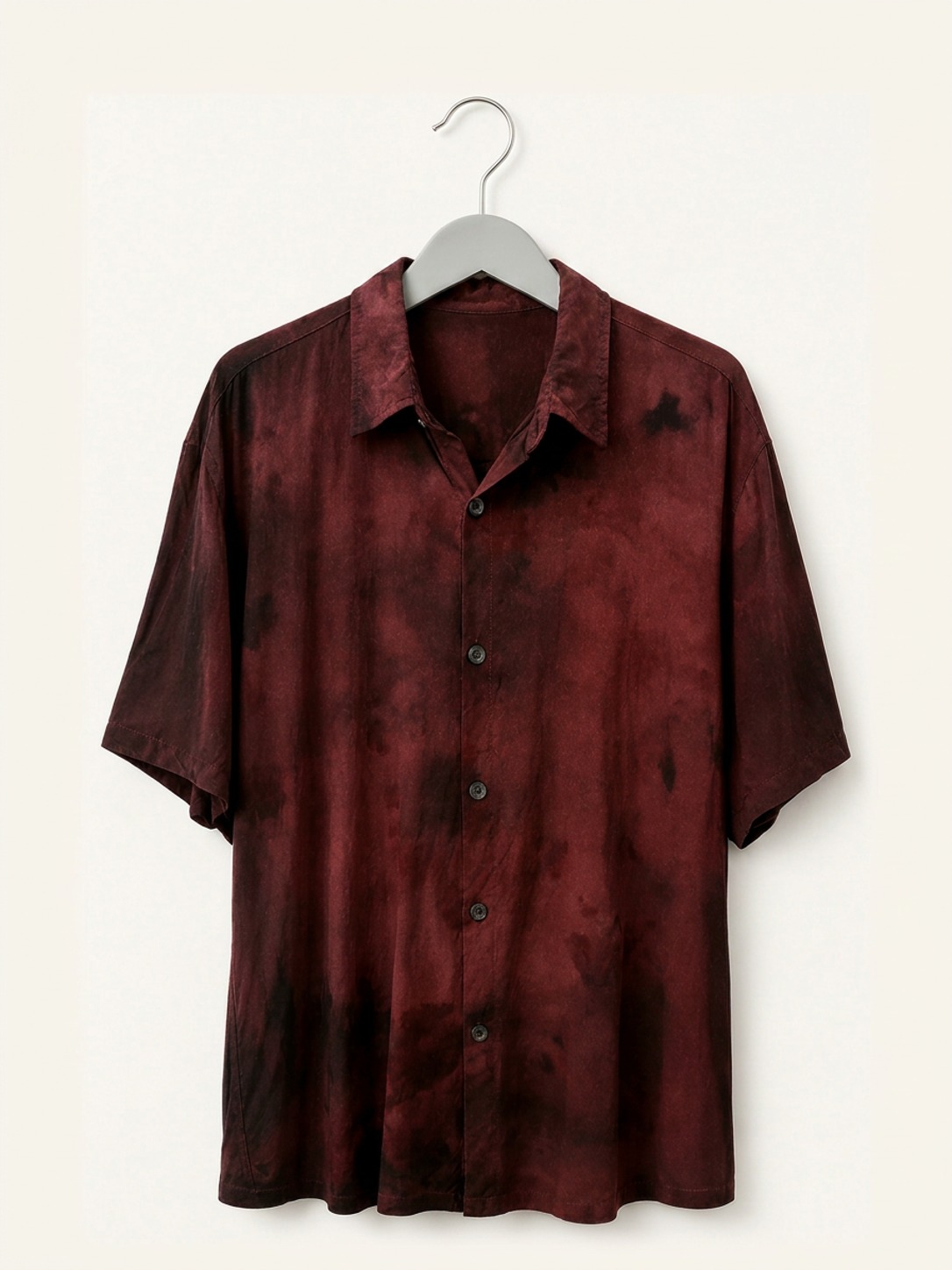 Hand ice-dyed bamboo collar shirt in deep red and black on a wooden hanger